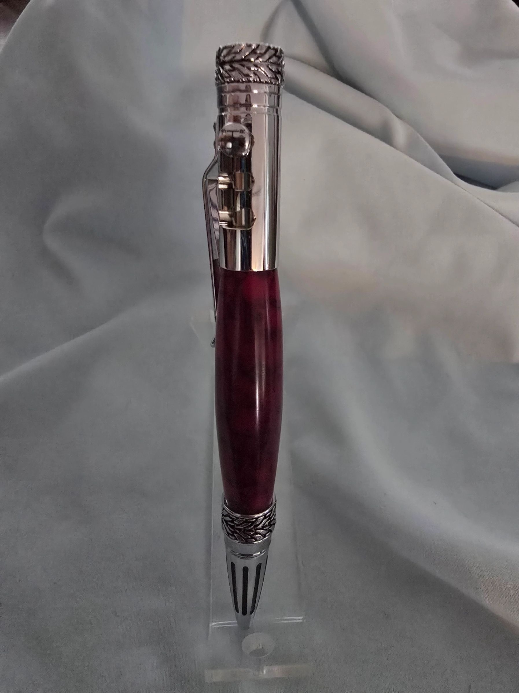 Luxury burgundy ballpoint pen with ornate silver accents
